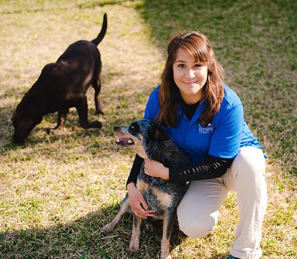 Staff member hugging a dog
